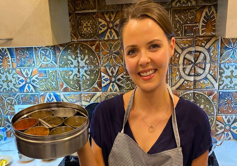 British girl holding indian spice box