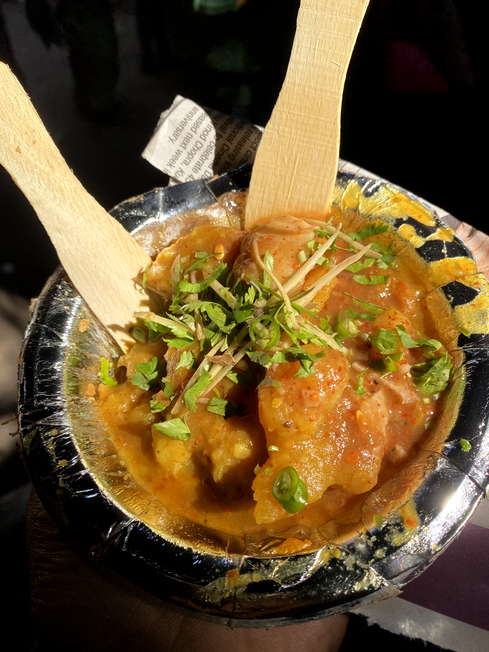 A variety of Indian street food dishes laid out at a market in Delhi