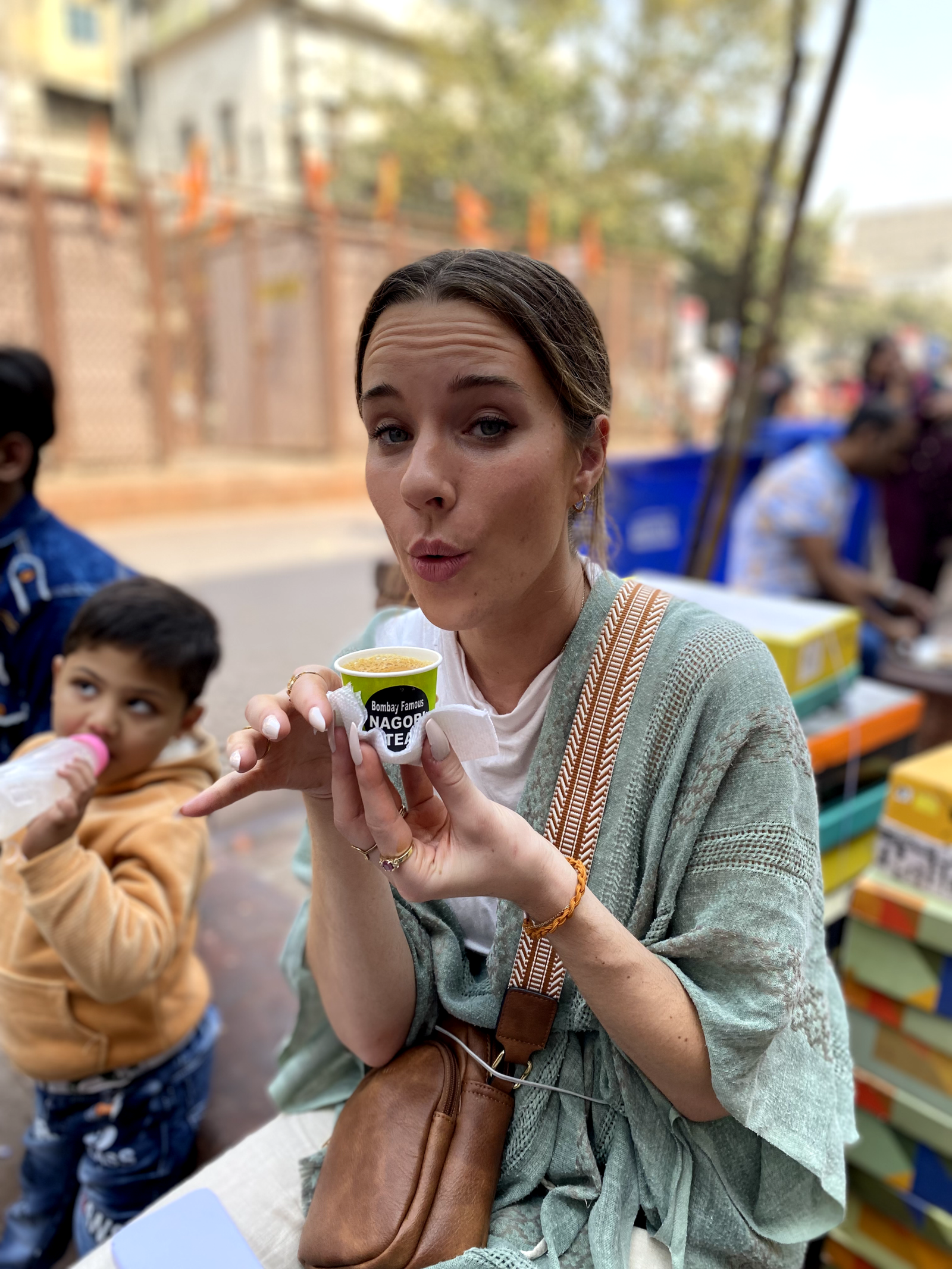 Solo female traveler sipping chai at a tea stall in India