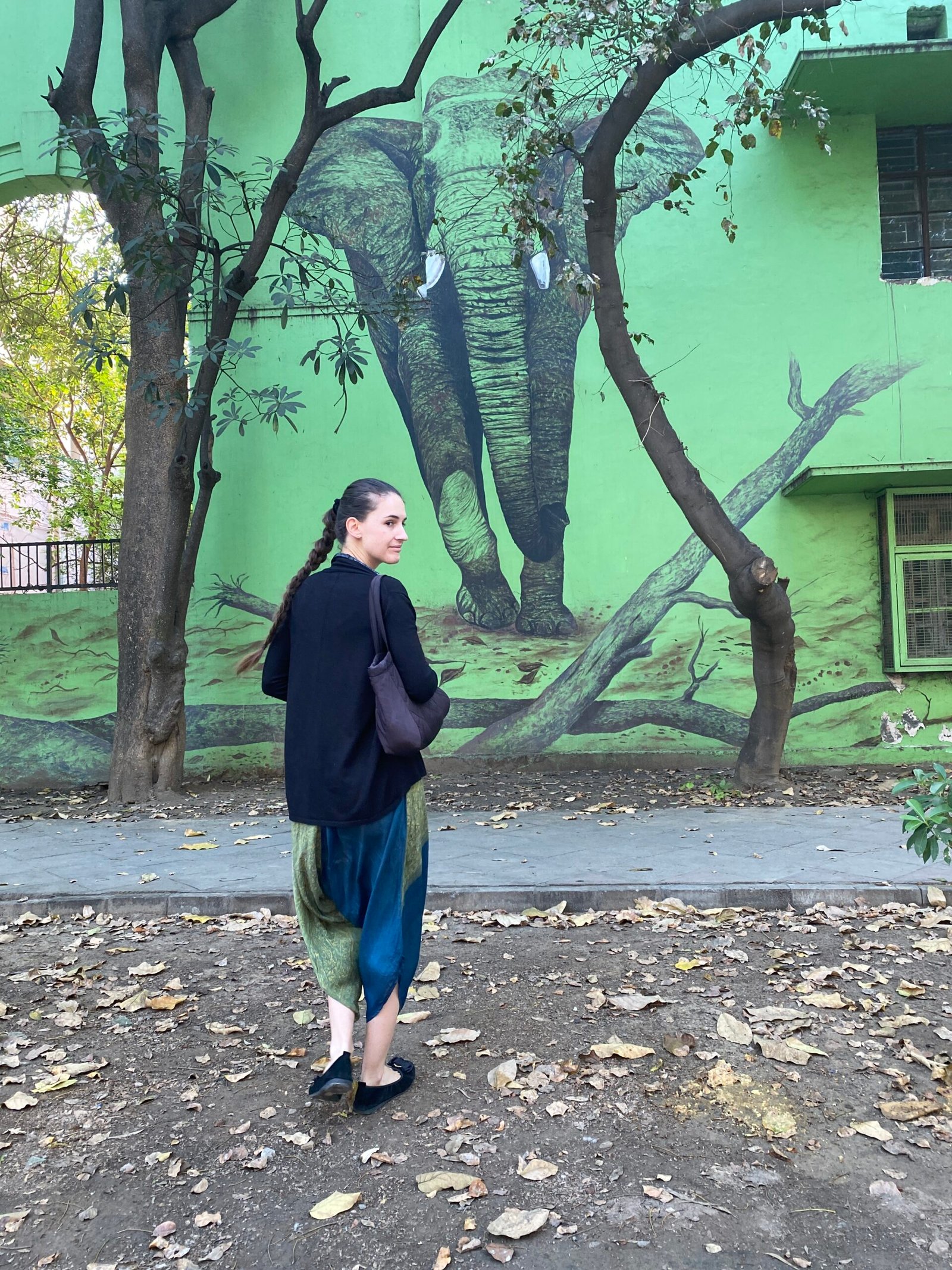 Female traveler exploring Delhi streets dressed appropriately for the weather and culture