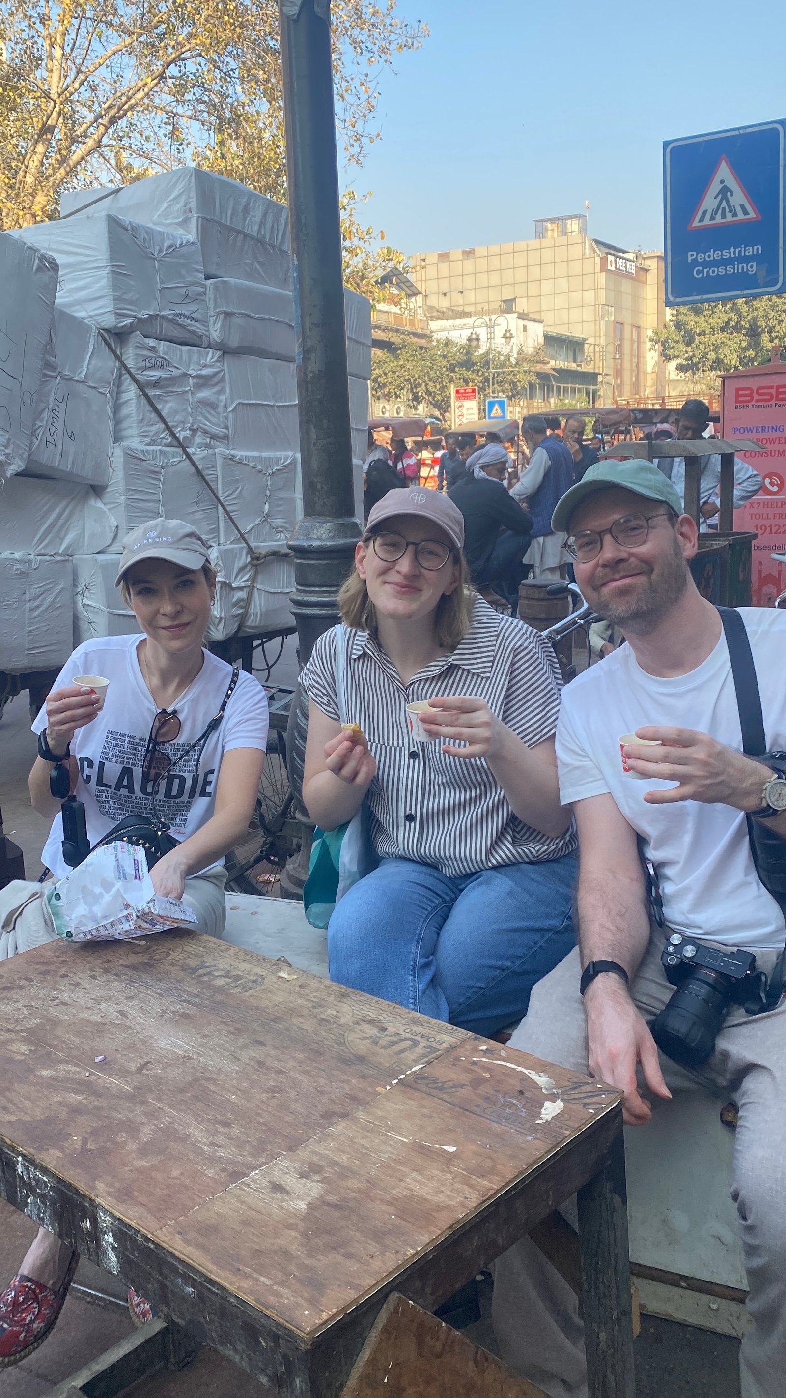 International tourists trying masala chai at a local tea stall on an Old Delhi guided experience