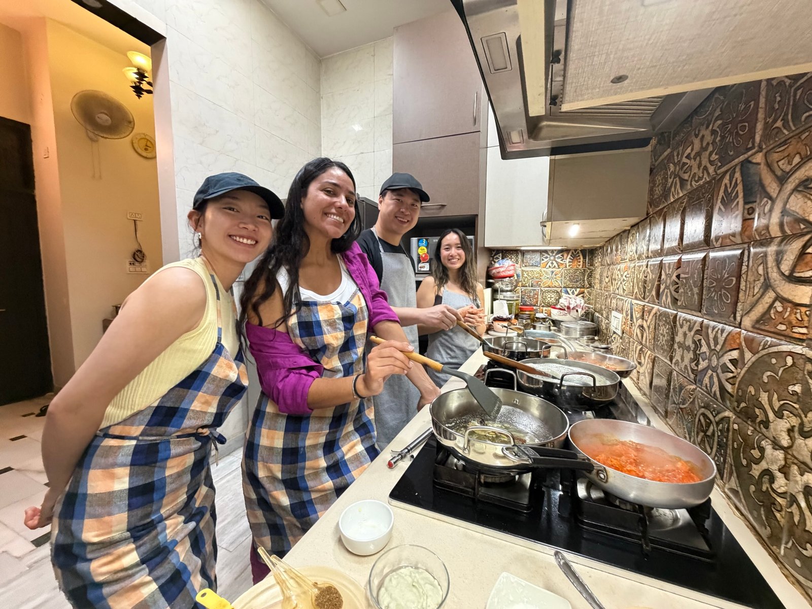 Group of women enjoying a cooking class experience during their India trip