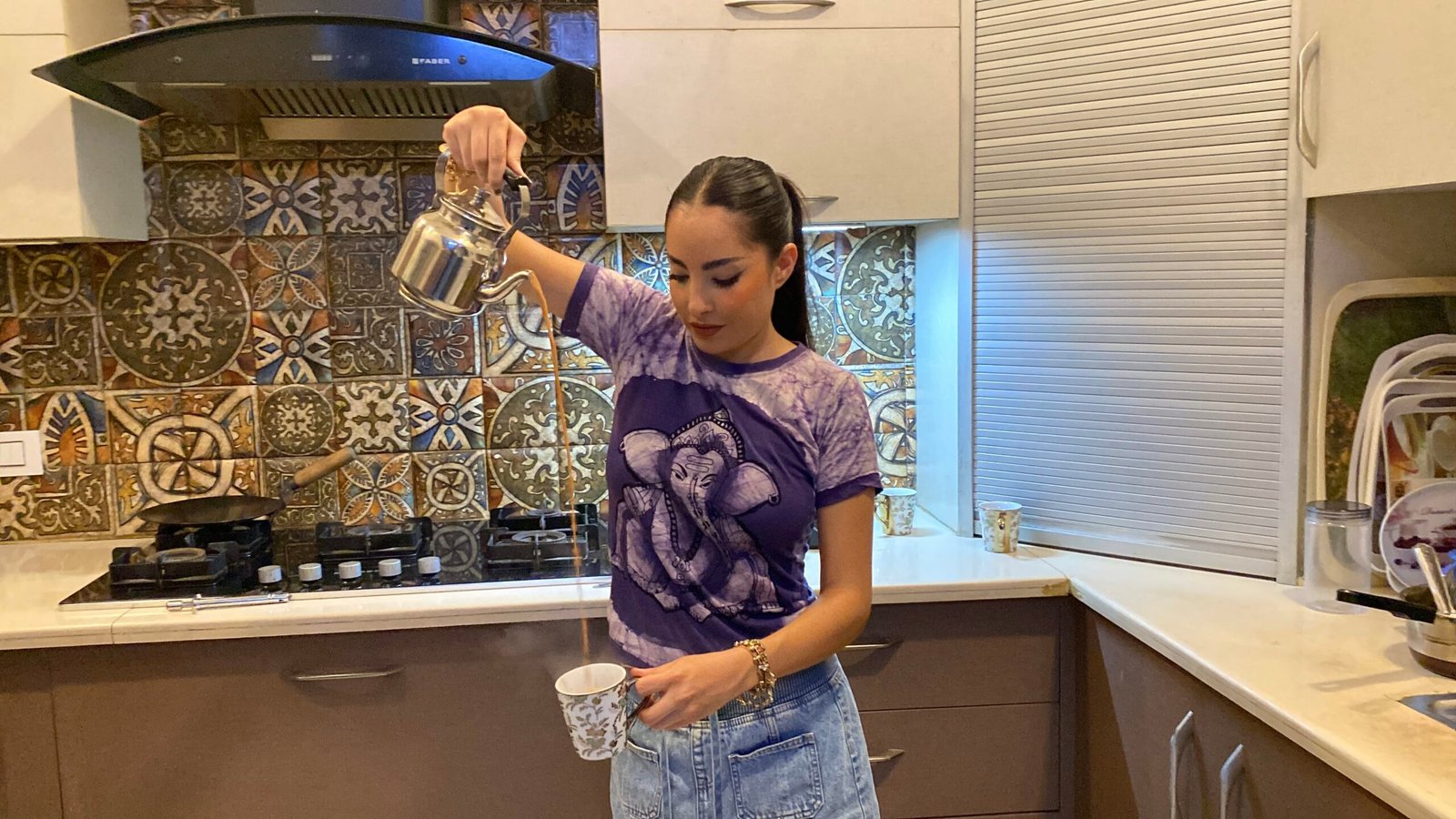 Solo female traveler pouring chai at a tea experience in New Delhi