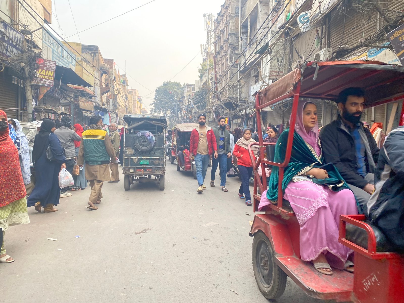 Busy lanes of Chandni Chowk market in Old Delhi with shops and pedestrians