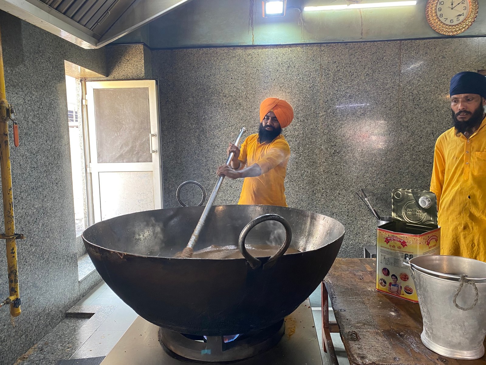 Volunteers serving free langar food to visitors at a Delhi Sikh temple