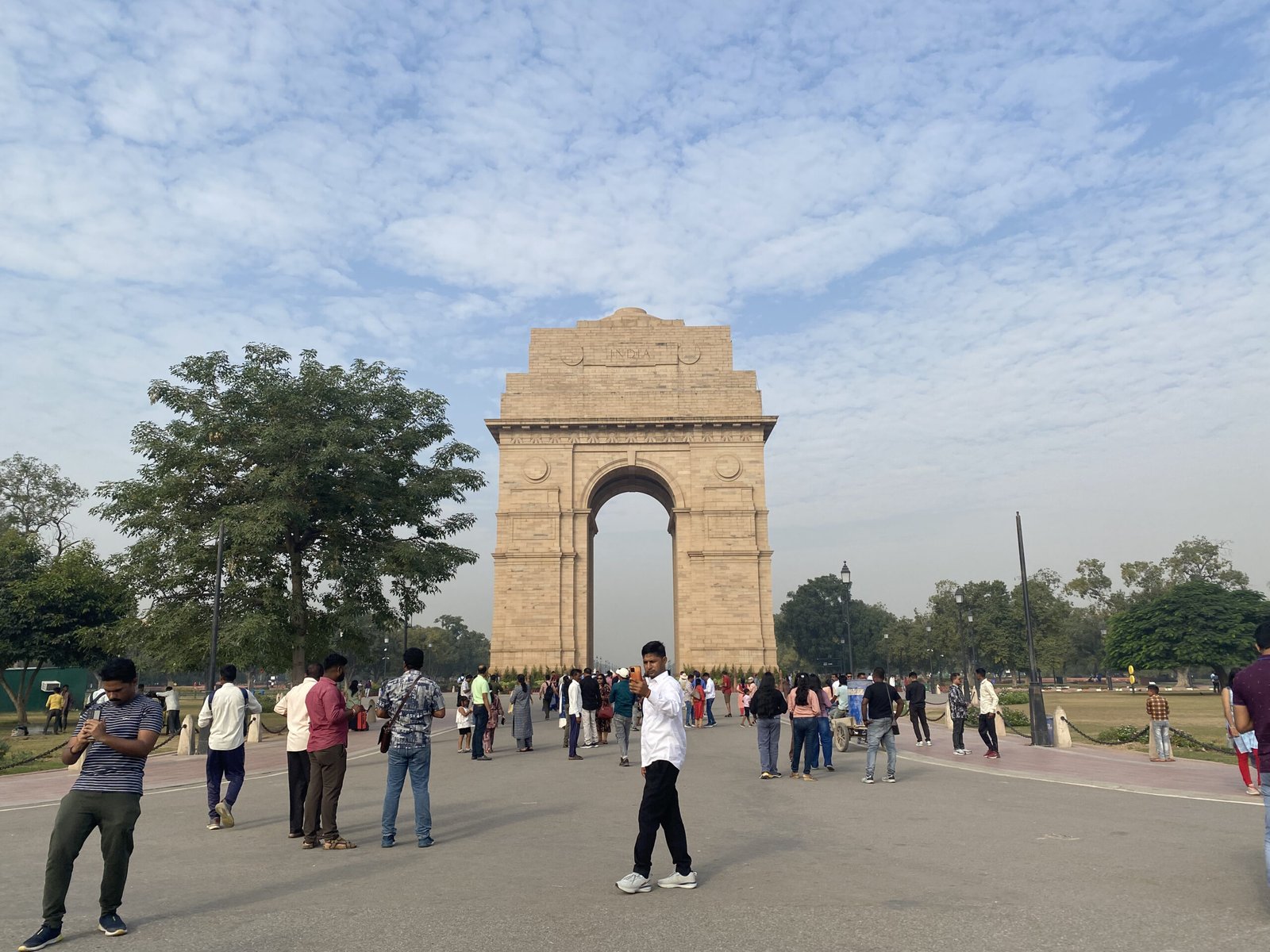 Visitors walking on the lawns near India Gate Delhi