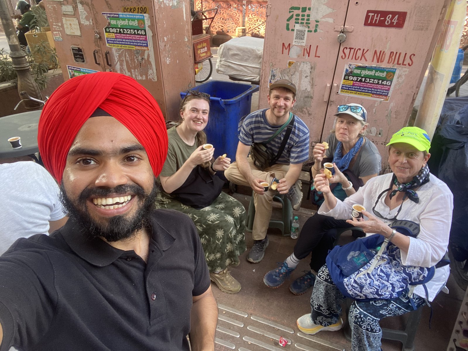 Food Tours Delhi guide JD with happy international guests after an Old Delhi food tour
