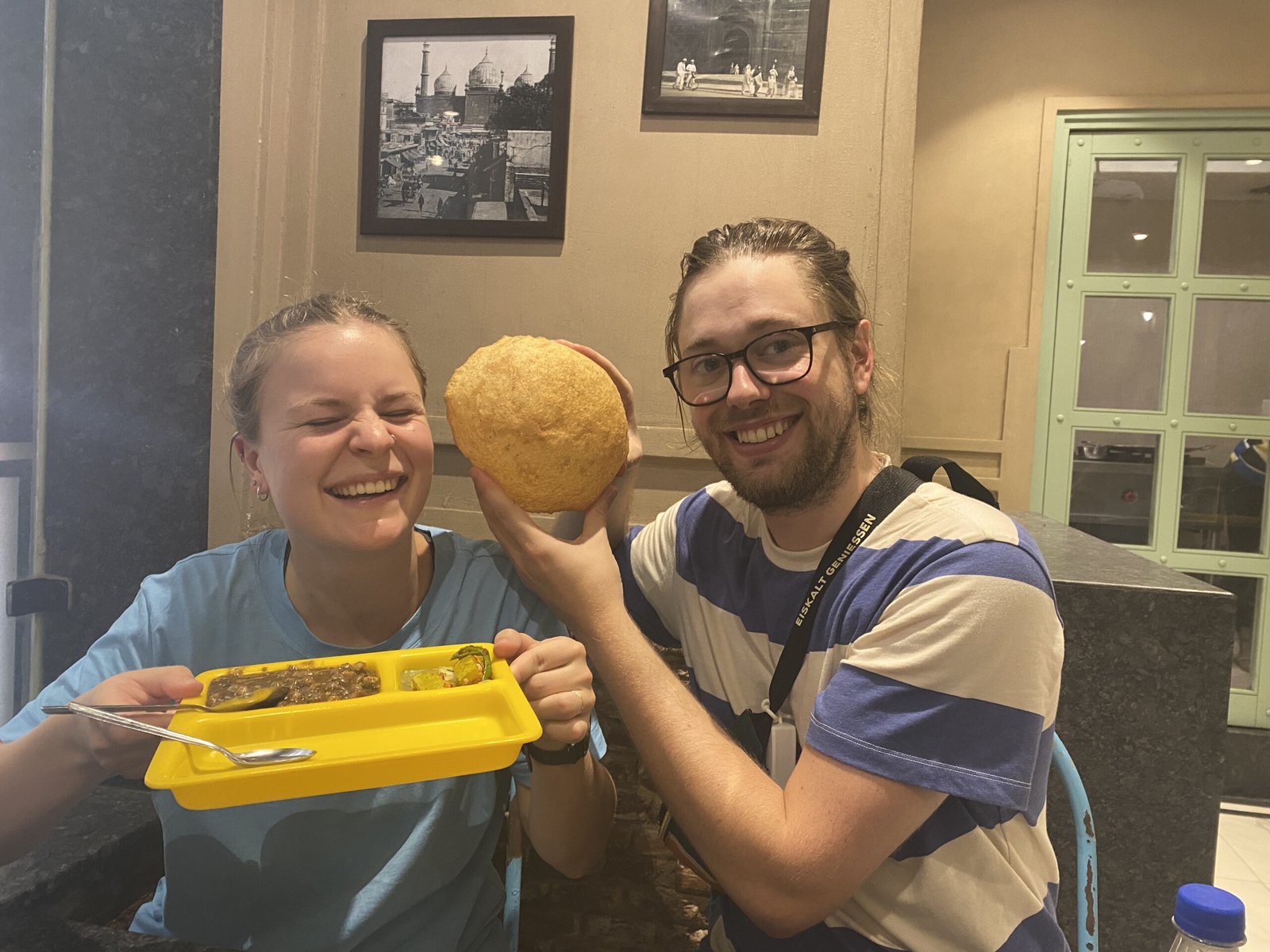 Happy guests on an Old Delhi food tour enjoying chole bhature