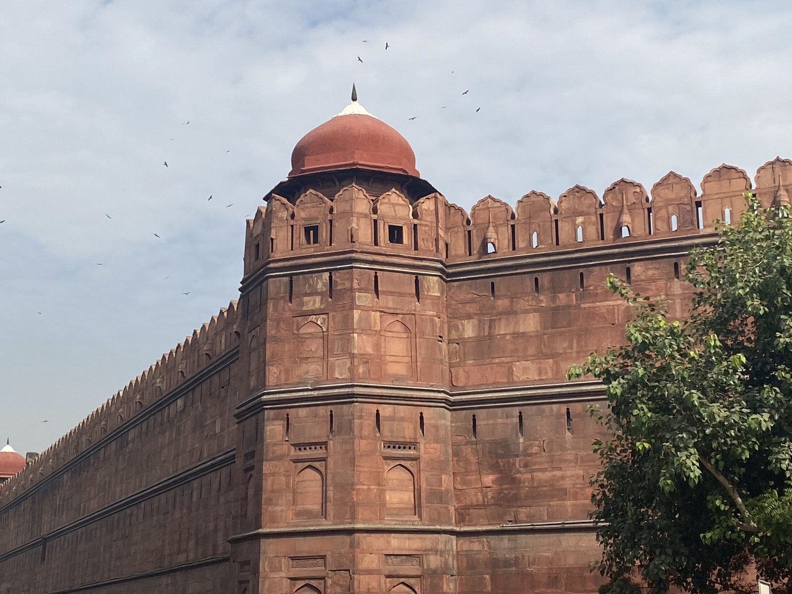Side angle view of the red sandstone walls of Lal Quila Delhi