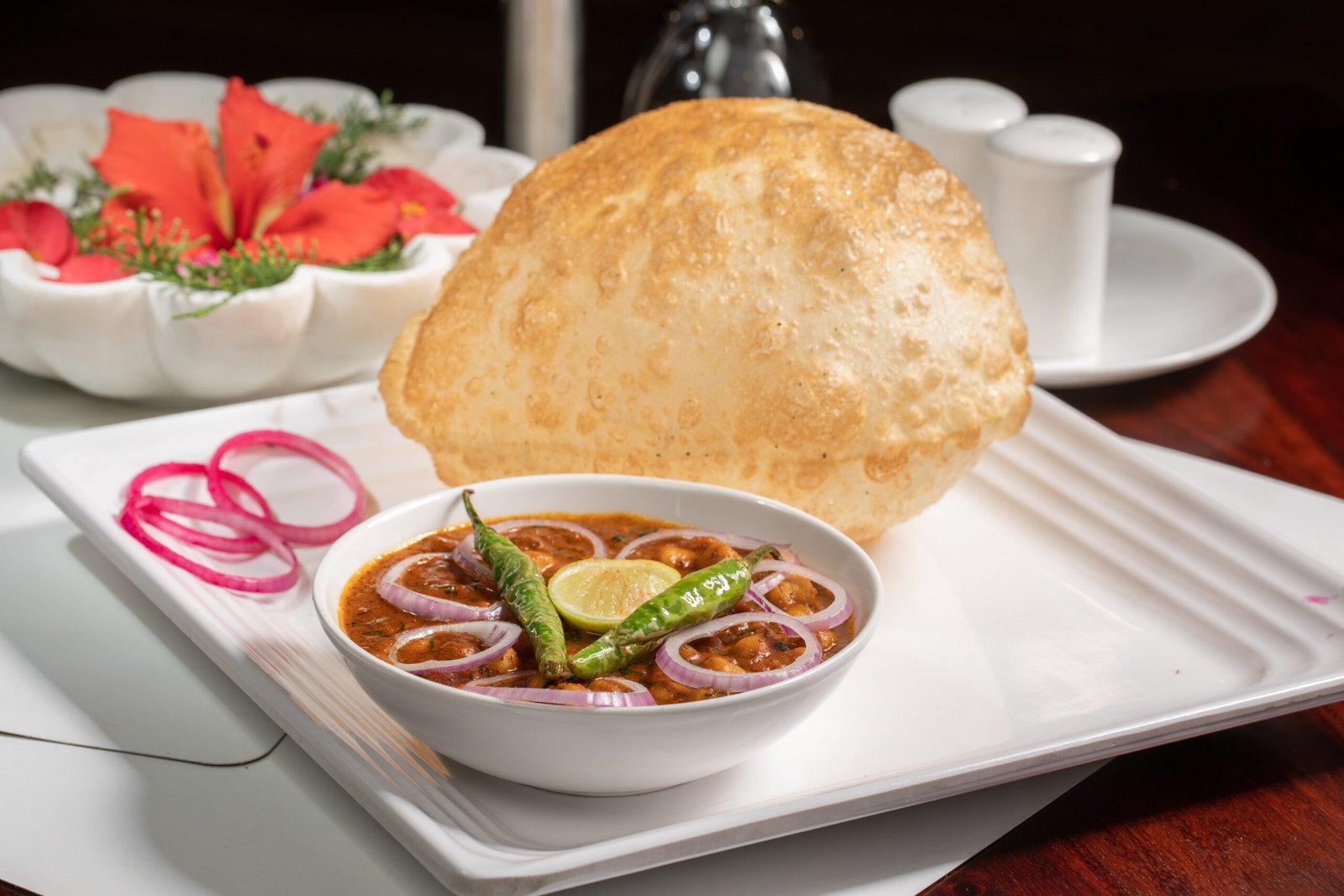 Chole bhature spicy chickpea curry with fried bread served on a plate