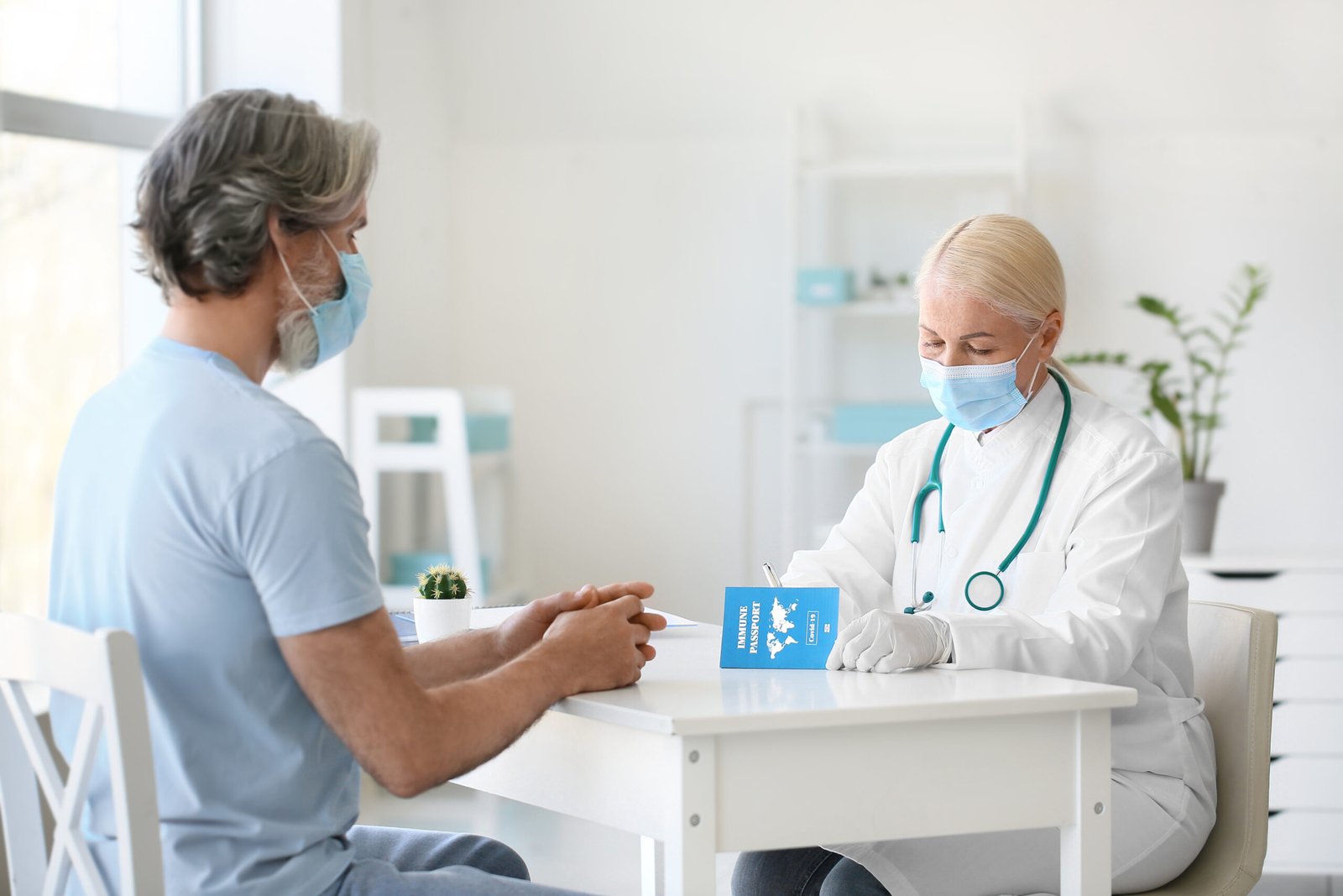 Doctor recording travel vaccinations before a trip to India