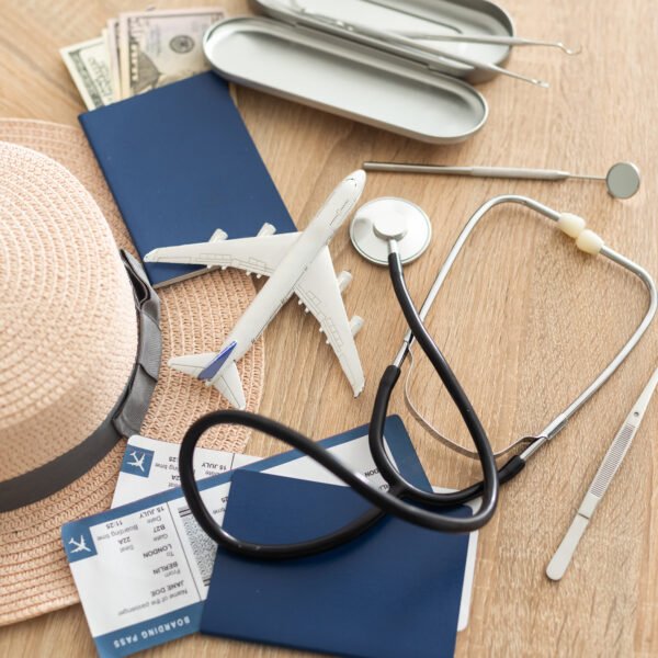 Medical Tourism, medical travel concept. Stethoscope, toy plane and passport on wooden background