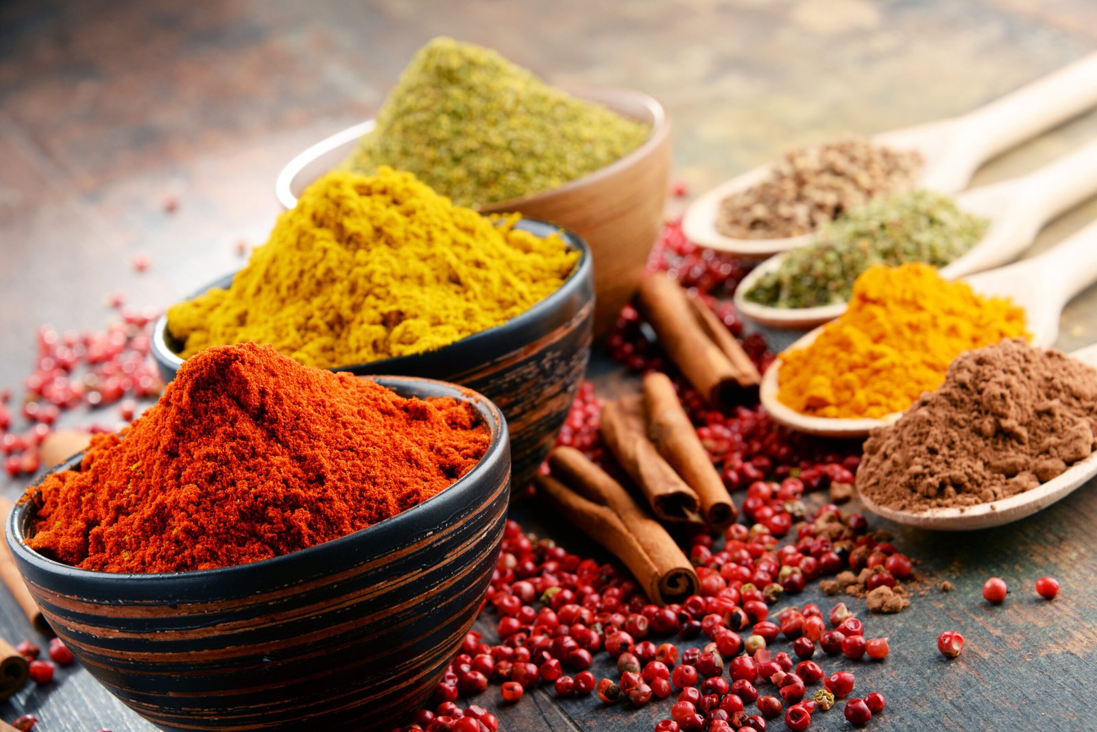 Variety of essential Indian spices arranged on a kitchen table