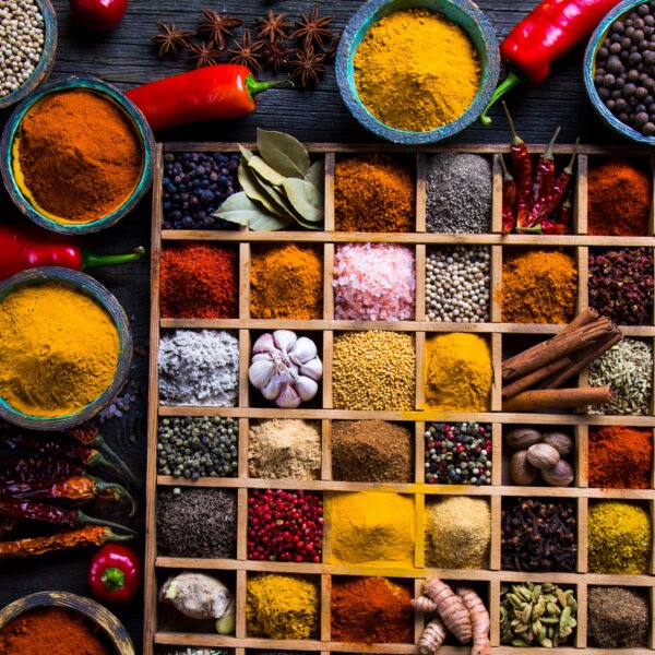 Variety of wooden box, spices and herbs on kitchen table