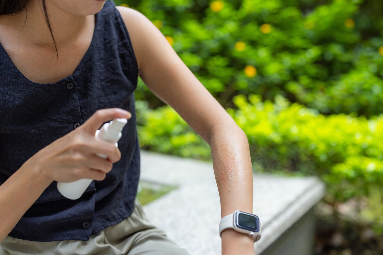 Traveler applying mosquito repellent as a precaution against insect borne illness in India