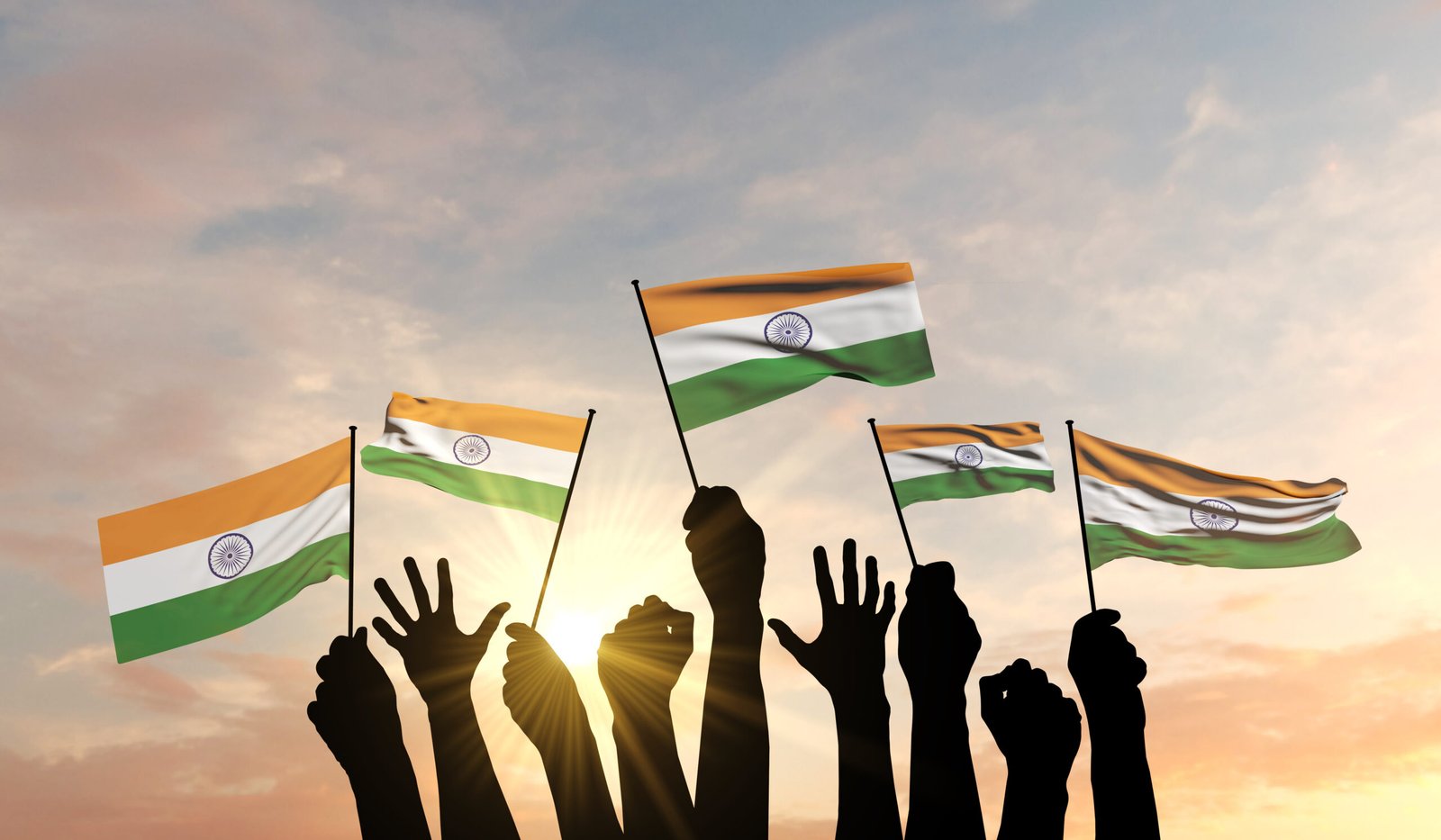 Silhouette of raised arms waving the Indian flag with pride, symbolising Independence Day spirit in Delhi