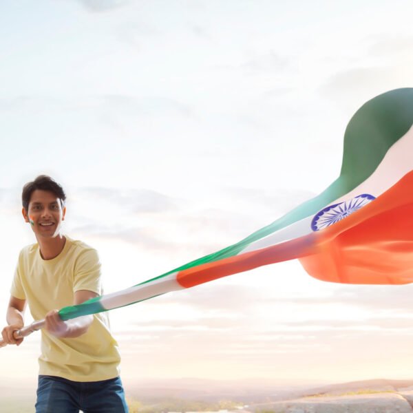 young man proudly waving national flag